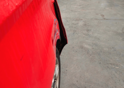 Red car bumber side damage